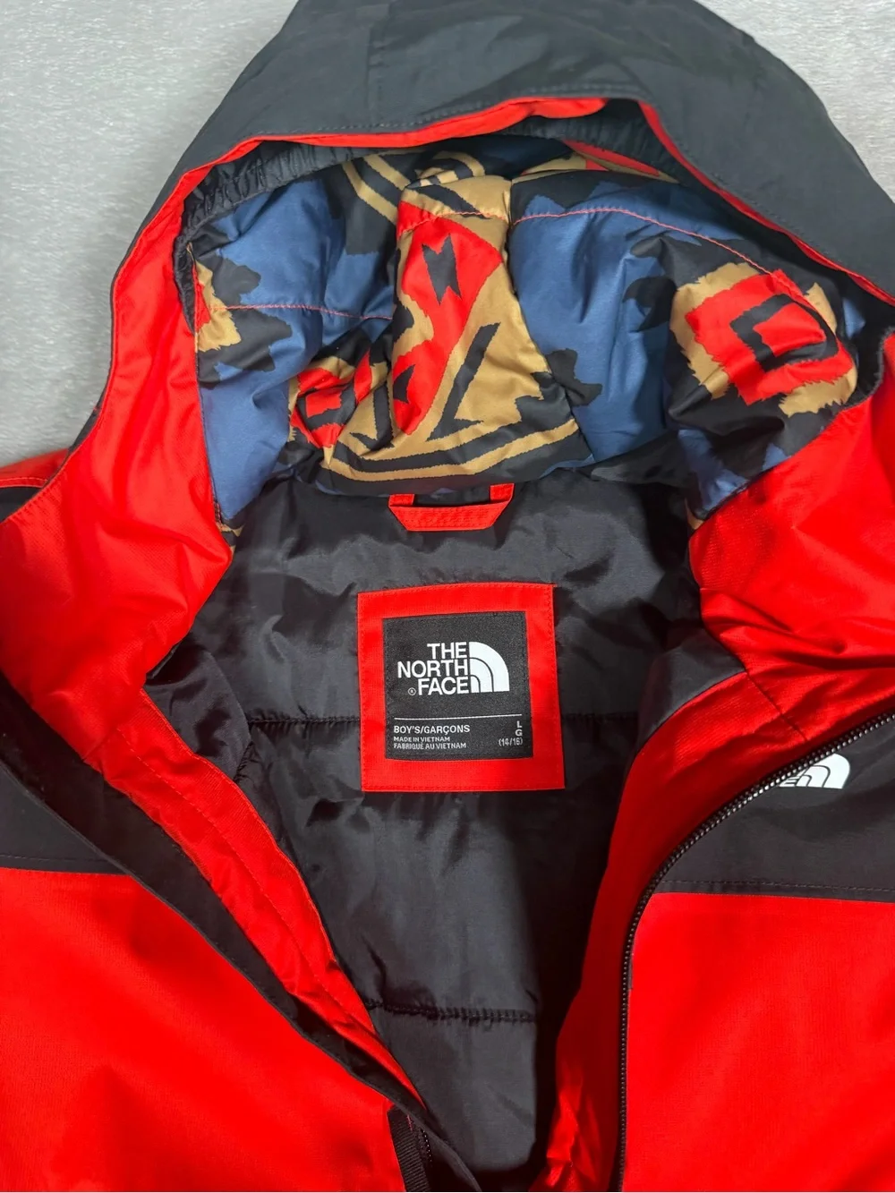 The North Face Red and Black Hooded Raincoat with Patterned Lining